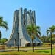 Kwame Nkrumah Mausoleum, a tall concrete monument with palm trees in Accra, Ghana